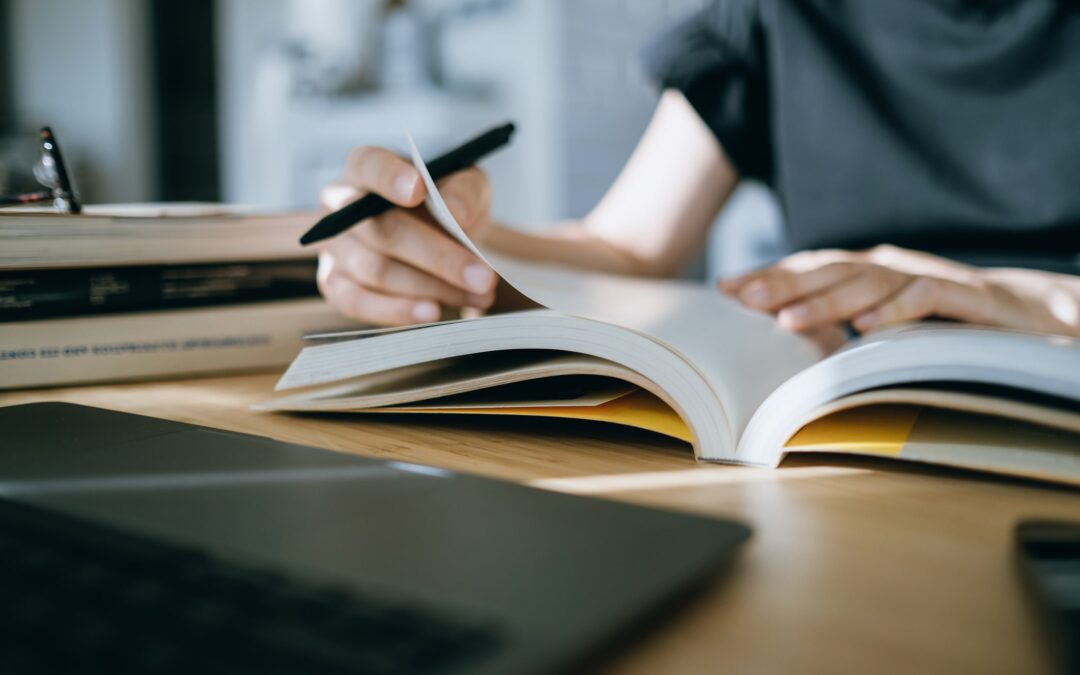 Young attorney reading and making notes in a book